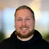 Aarni smiling, in a black hoodie